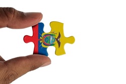 Hand holding piece of jigsaw puzzle with flag of Ecuador. Jigsaw puzzle of Ecuador flag on white background.