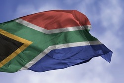 South Africa flag isolated on the blue sky with clipping path. close up waving flag of South Africa. flag symbols of South African.