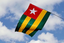 Togo flag isolated on sky background. close up waving flag of Togo. flag symbols of Togolese.