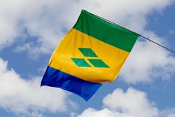 Saint Vincent flag isolated on sky background. close up waving flag of Saint Vincent. flag symbols of Saint Vincent.
