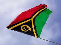 Vanuatu's flag is isolated on a sky background. flag symbols of Vanuatu. close up of a Vanuatuan flag waving in the wind.