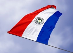 Paraguay's flag is isolated on a sky background. flag symbols of Paraguay. close up of a Paraguayan flag waving in the wind.