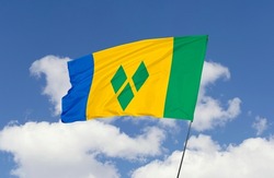 Saint Vincent flag is isolated on the blue sky with a clipping path. flag symbols of Saint Vincent and The Grenadines.