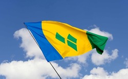 Saint Vincent and The Grenadines flag isolated on the blue sky with clipping path.