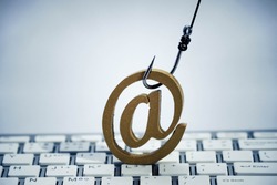A fish hook with email sign on  computer keyboard / Email phishing attack concept