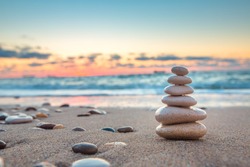 Stones balance on beach, sunrise shot. Zen meditation and relaxation