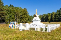 Ritual Buddhist stupa Enlightenment on summer meadow against forest near Krasnoyarsk, Russia. Translation: Buddhist Bodhi Stupa