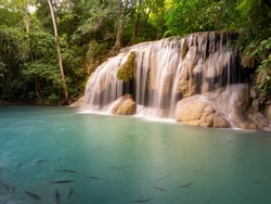 Clean green emerald water from the waterfall Surrounded by small trees - large trees,  green colour,  fish live in the pond, Erawan waterfall, Kanchanaburi province, Thailand