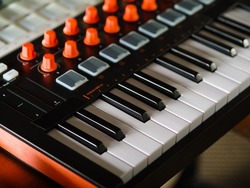 Close-up. Modern electronic musical instrument - midi keyboard. Professional equipment for a recording studio. There are no people in the photo.
