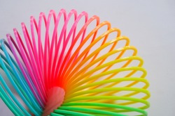colorful plastic coil on white background, plastic toy spring