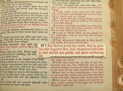 John 3:16 in close up imposed upon page in Bible