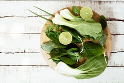 wet fresh greenery on cutting board. Diet salad, detox drink ingredients. Healthy food background. Text space