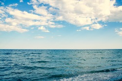 Seascape background wavy blue sea and sky with clouds