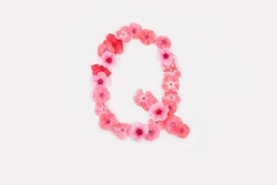 A letter Q made from real fresh flowers. Creative floral font concept. Unique collection of letters and numbers for design. Spring, summer, autumn and valentines, creative idea, selective focus