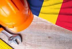 Romania flag with different construction tools on wood background, with copy space for text. Happy Labor day concept.