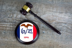 Wooden judgement or auction mallet with of Iowa flag. Conceptual image.