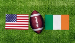 Top view ball for american football with USA vs. Irish flags match on green american football field