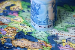 Russian rubles on map of Ukraine and Russia. Concept of russian support of Donbass