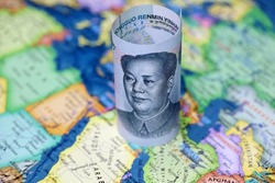 Chinese yuan on the map of Saudi Arabia and Iran. Concept of buying oil, economic cooperation between the Beijing and Persian Gulf countries