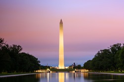 Washington Monument with brilliant sunrise over reflecting pool, Washington DC, USA