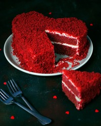 heart shaped red velvet cake on dark background slide aside