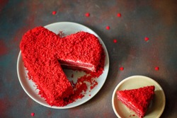 heart shaped red velvet cake on dark background slide aside