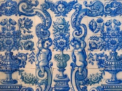 Traditional Portuguese, glazed ceramic tiles. Azulejos white, blue ornate pattern, for design, backdrop. Abstract background from old decorative painted tiles, religious theme with angels and flowers.