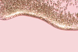 transparent liquid with gold glitter pouring over a pastel pink background festive backdrop for your project