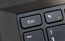 Laptop computer keyboard Esc, escape key macro detail, top view, object extreme closeup, from above, nobody. Stop, no, quit, cancel, abort key, escape sequence character, aborting and halting concept