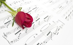 A red rose and sheet music.