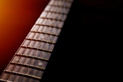 detail of the Electric Guitar Fret Board, guitar against a black background