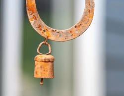 Rusted bell on a rusted horseshoe