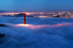 Golden Gate at night surrounded by fog