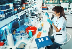 Young scientist works in modern biological lab