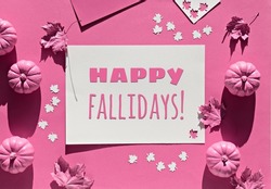 Pink fuchsia paper background with Autumn decor. Text Happy Fallidays in frame. Monochromatic flat lay, magenta pumpkins. Hand with dry Fall leaves painted metallic pink.