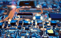 Closeup on electronic board in hardware repair shop, blurred and toned image. Shallow DOF, focus on the middle left field