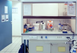 Scientific background: blurred interior of laboratory fume hood in modern laboratory. This is defocused background image, no focus point here. Can be used as a background for your presentation. 