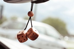 Cubes on the car mirror. A symbol that brings good luck. happy travels. High quality photo