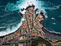 Aerial view of Punta Brava, near the town of Puerto de la Cruz on the island of Tenerife, Canary Islands, Atlantic Ocean, Spain. Drone colorful houses and black lava rocks in small fisherman village.