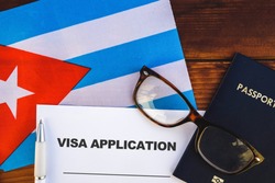  Flag of Cuba , visa application form and passport on table
