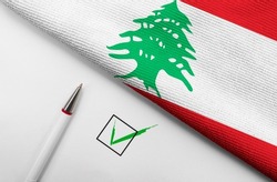 Pencil, Flag of Lebanon and check mark on paper sheet 