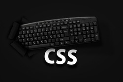 PC keyboard with CSS word on black background 