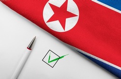 Pencil, Flag of North Korea and check mark on paper sheet 