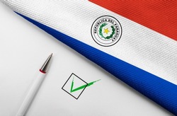 pencil, flag of Paraguay and check mark on paper sheet 