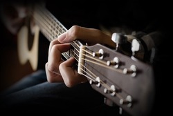 Acoustic Guitar Playing. Young men Playing Acoustic Guitar Closeup Photography. Blurred concept