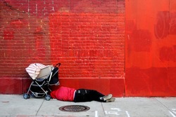 Man sleeping in front of red wall