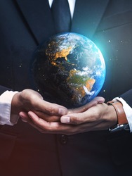 Businessman Holding Earth. Save Earth Concept. Elements of this image furnished by NASA