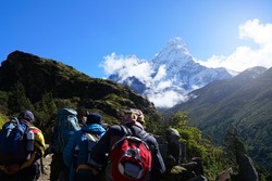 Four Trekkers Walking on Everest Highway While Seeing Mount Ama Dablam, Everest Base Camp Trek From Tengboche to Dingboche , Nepal