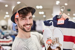 Happy young man shopping by fashion with 50% off discount