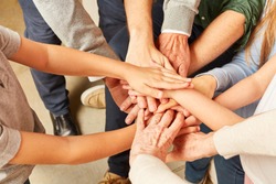 Extended family puts many hands on each other as a symbol of solidarity or network